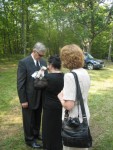 Kris (Arthur's mom) putting on Art's boutonniere; Sue (Diana's sister) watching