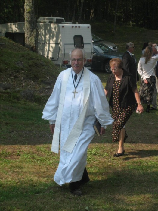 The minister coming up the hill with his wife.