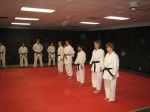 Everyone lining up to find out if they passed.  Three 1st degree black belts testing for 2nd degree, Cathy, and Emily