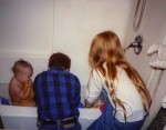 Brian and Emily giving Cate a bath