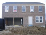 Front of house, brick finished, drywalled garage