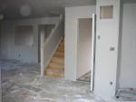 Living room, looking at garage entry door and stairs