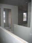 Standing in the doorway of the guest room, looking across stairs into office.  Guest bathroom on left.