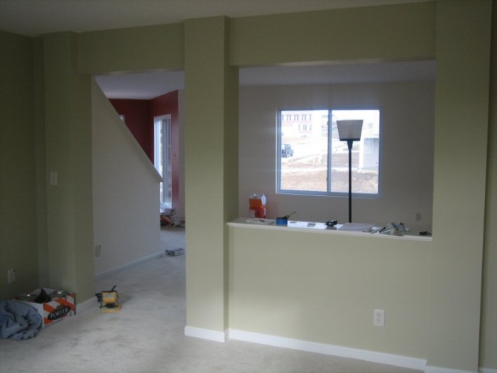 Looking from front room, through living room into kitchen (red)