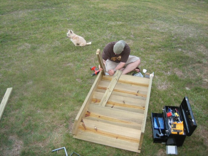 Paul adding the support legs while Meg stands guard