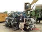 Erik showing his skills of mass destruction.  He crushed this very car. With his bare hands!*

*and a little help from the crusher behind him.
-photo: Joanna Schroder