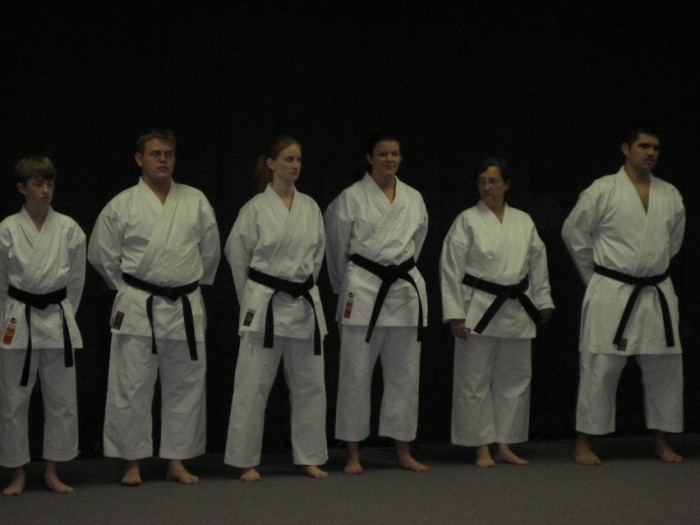 Black belts standing in line before the graduation