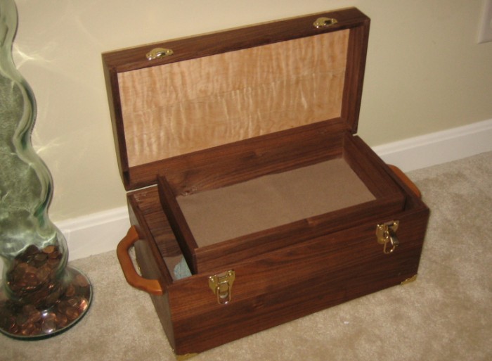An open view of the chest, showing the matching tray insert with felt liner.