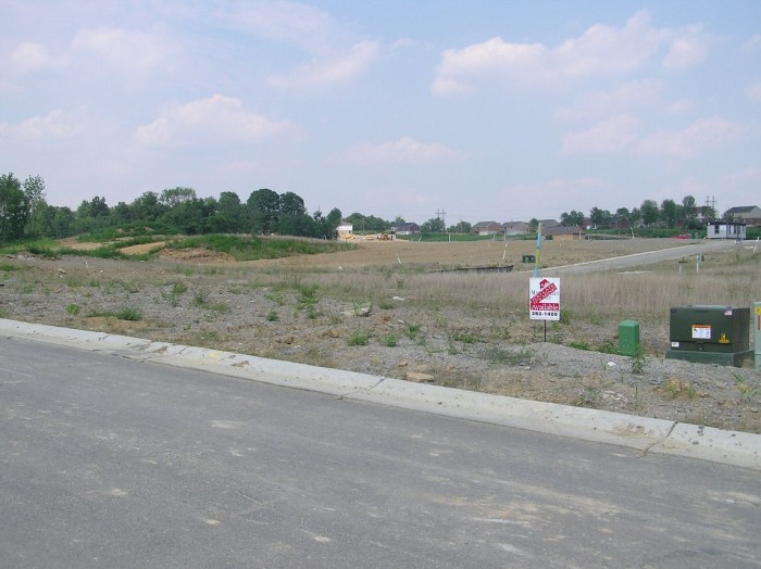 This is standing in the lot across the street looking down and to the left at our lot.  the right border for our lot is that electrical box.