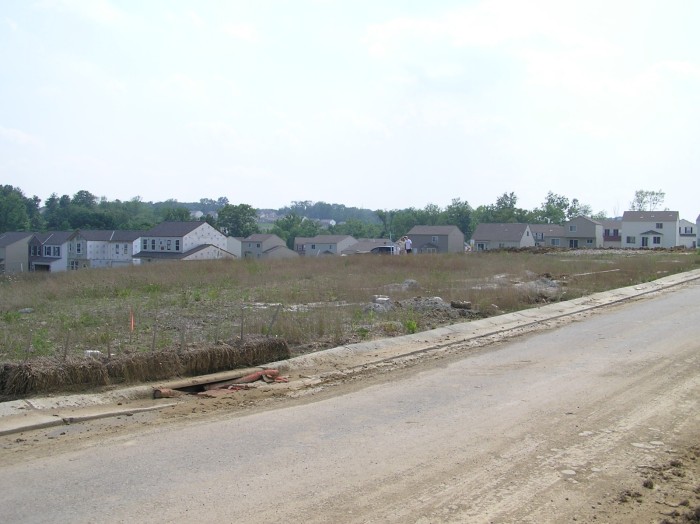 Anothe rear corner shot, this time you can see Emily and Philip standing by the electrical box that marks the front right property line.