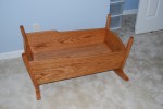 The cradle is solid oak, and is beautiful!
