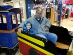 Uncle Sean and Sean riding the train at the mall.