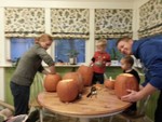 Carving pumpkins the night before Halloween.